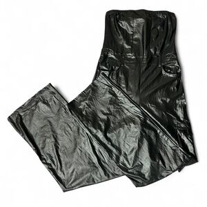 Black faux leather strapless jumpsuit with belt buckle and pocket accents